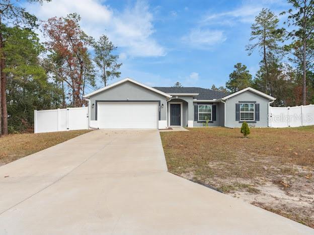 single story home with a front yard and a garage