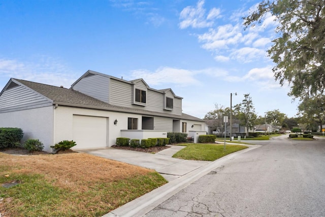 view of front of house featuring a garage and a front lawn