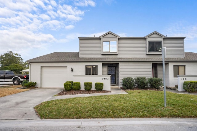 view of front of house featuring a garage and a front lawn