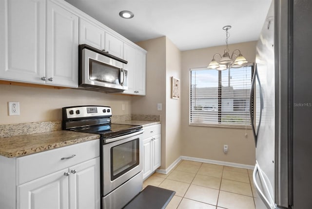 kitchen featuring white cabinets, decorative light fixtures, stainless steel appliances, and an inviting chandelier