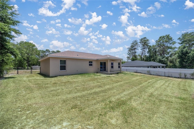 rear view of house with a yard