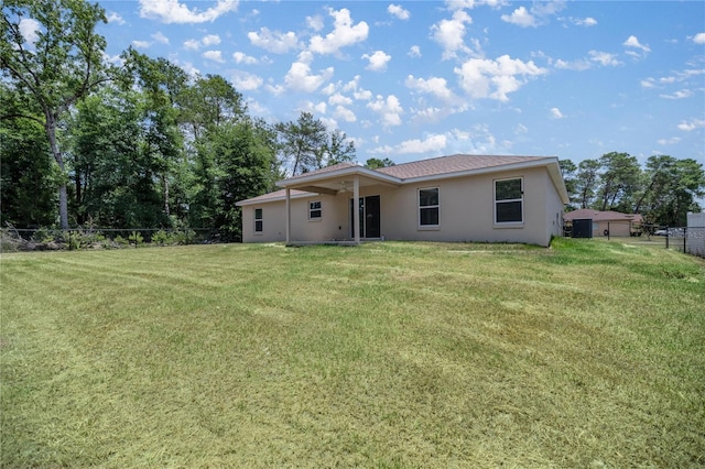 rear view of house with a lawn