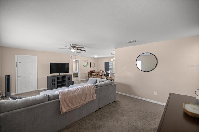 living room featuring ceiling fan and carpet floors