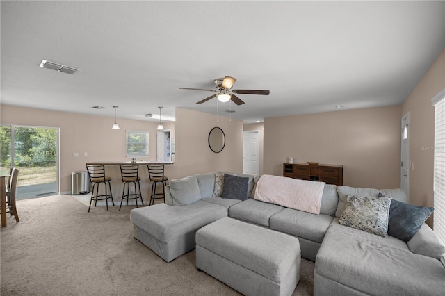 living room with light carpet and ceiling fan