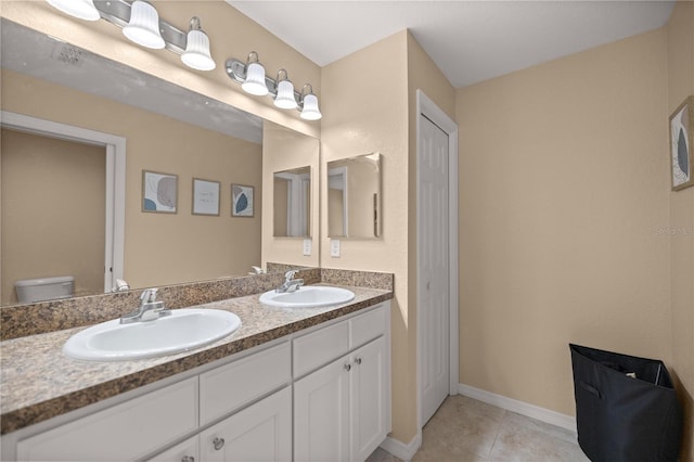 bathroom with tile patterned floors, vanity, and toilet