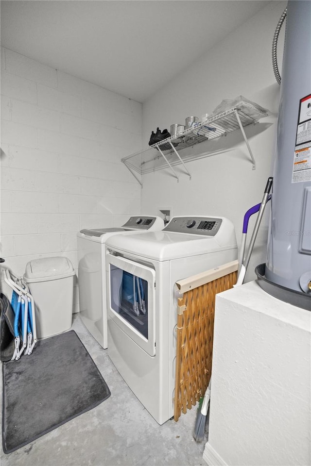 washroom with washer and dryer and water heater