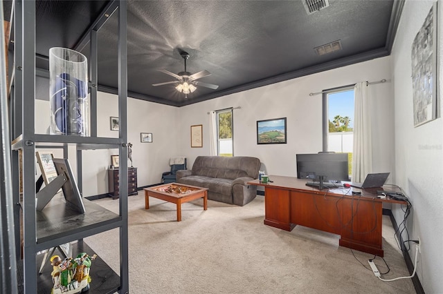 carpeted office space with ceiling fan, a textured ceiling, and ornamental molding