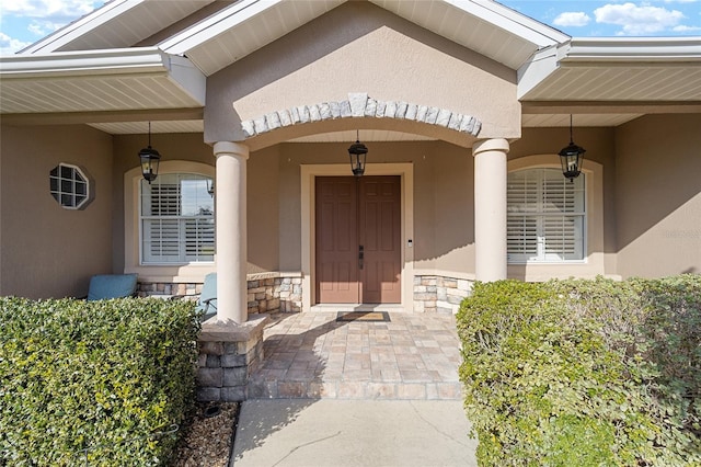 view of exterior entry with covered porch