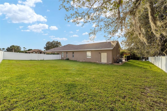 rear view of house with a lawn