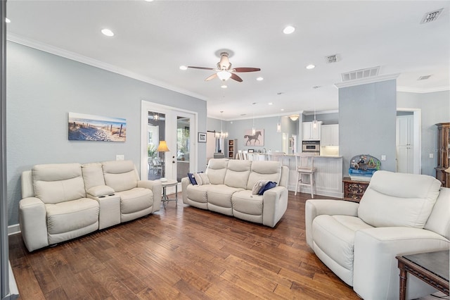 living room with crown molding, dark wood-type flooring, ceiling fan, and french doors