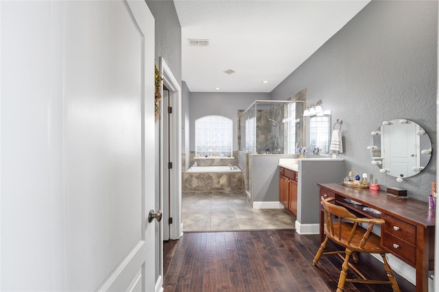 bathroom with hardwood / wood-style flooring, vanity, and separate shower and tub