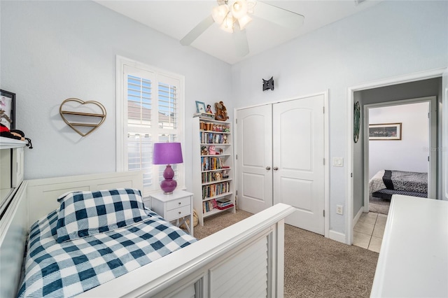 carpeted bedroom featuring a closet and ceiling fan