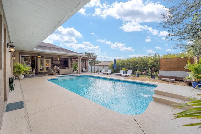 view of pool with ceiling fan, a patio, and an outdoor hangout area