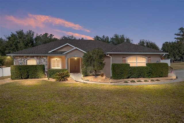 ranch-style home featuring a lawn