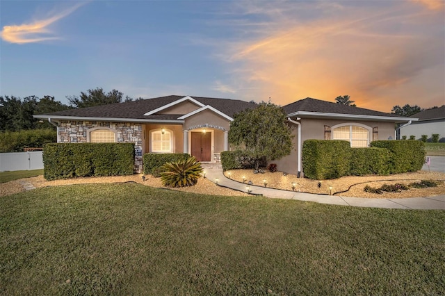 ranch-style home with a lawn