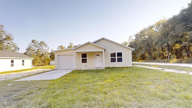 view of front of house with a garage and a front lawn