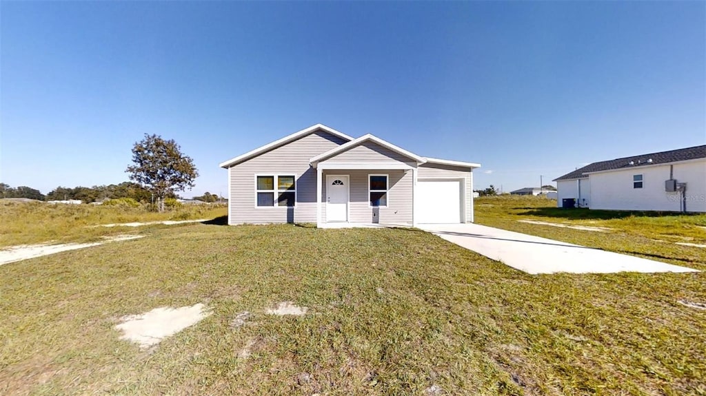 view of front of home with a front lawn and a garage