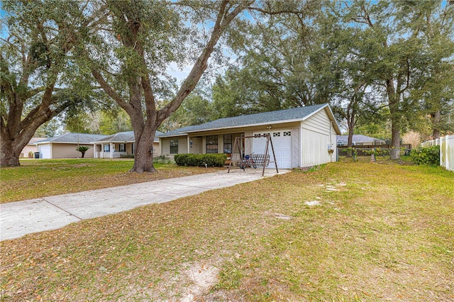 ranch-style house with a garage and a front lawn