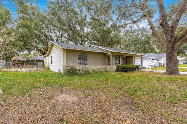 view of front facade with a front yard and a garage