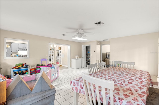 tiled dining space featuring ceiling fan