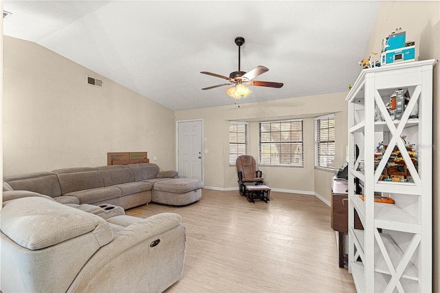 living room with hardwood / wood-style flooring, vaulted ceiling, and ceiling fan