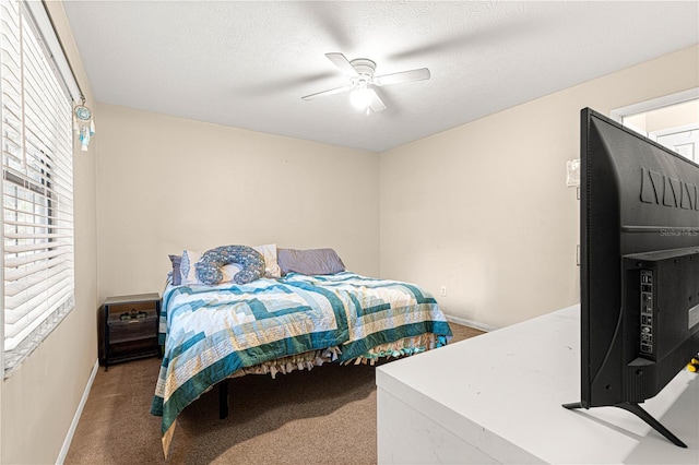 bedroom featuring a textured ceiling, carpet floors, and ceiling fan