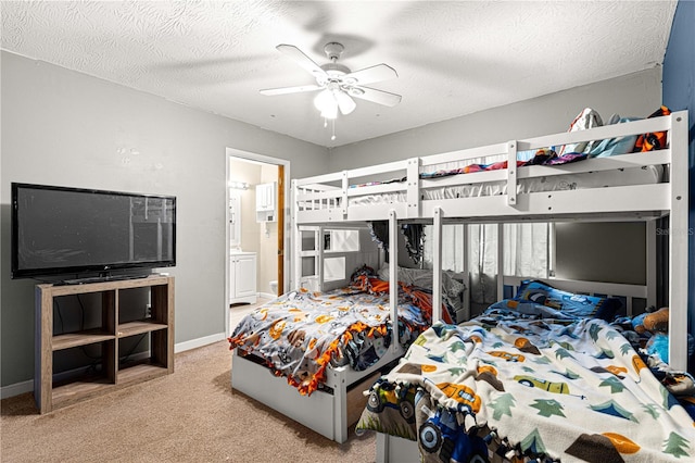 bedroom featuring ensuite bath, ceiling fan, light colored carpet, and a textured ceiling