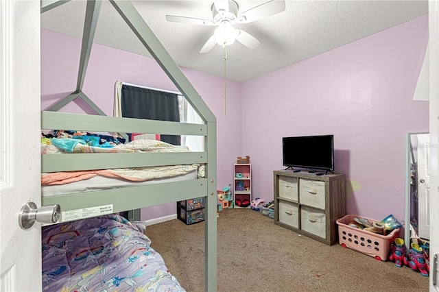 carpeted bedroom with a textured ceiling and ceiling fan