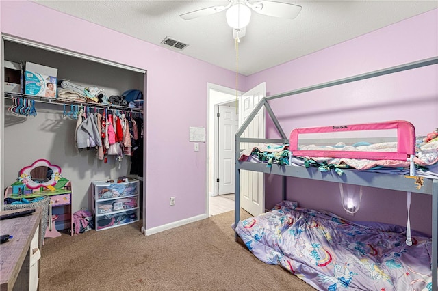 bedroom featuring carpet, ceiling fan, a textured ceiling, and a closet