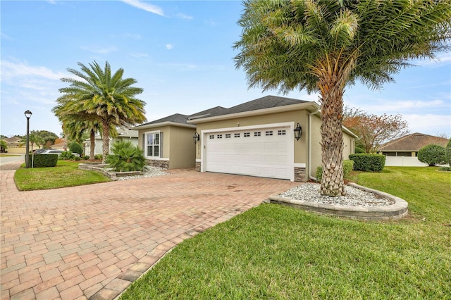 view of front of house featuring a garage and a front lawn