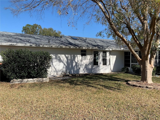 view of side of property with a lawn