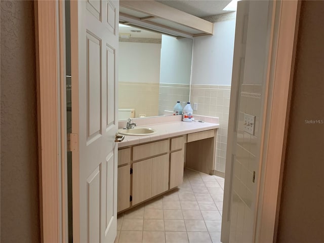 bathroom featuring tile patterned flooring, tile walls, and vanity