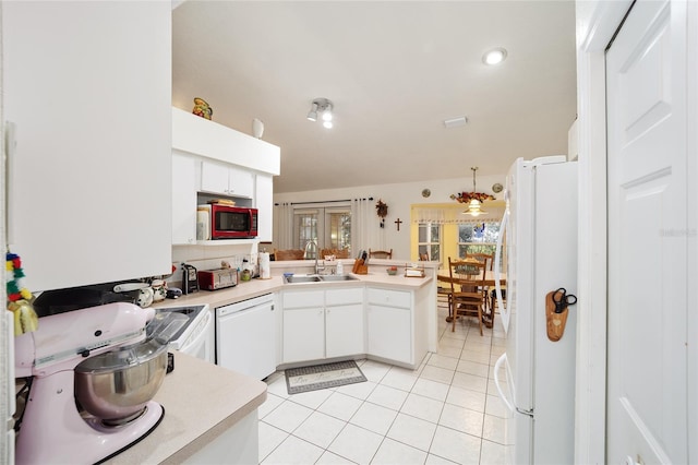 kitchen featuring sink, white cabinetry, white appliances, light tile patterned flooring, and kitchen peninsula