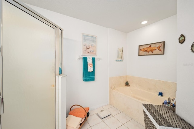 bathroom with tile patterned flooring and separate shower and tub