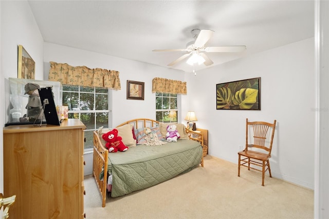 carpeted bedroom featuring ceiling fan and multiple windows