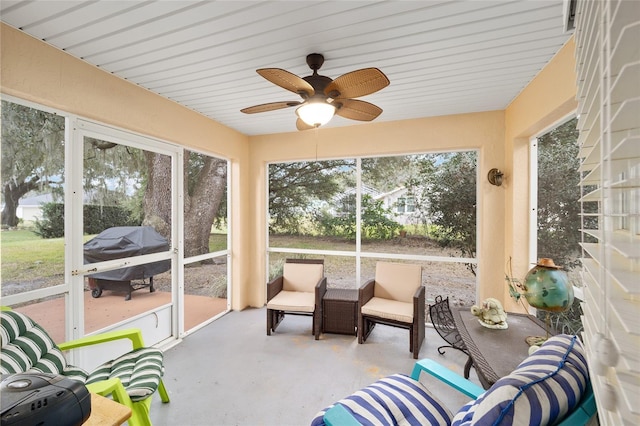 sunroom / solarium with ceiling fan and a healthy amount of sunlight