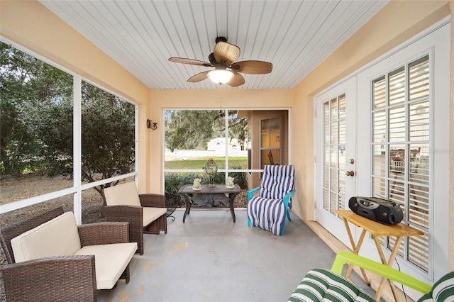 sunroom featuring ceiling fan and wooden ceiling