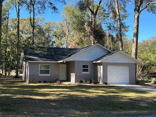 single story home featuring a garage and a front lawn