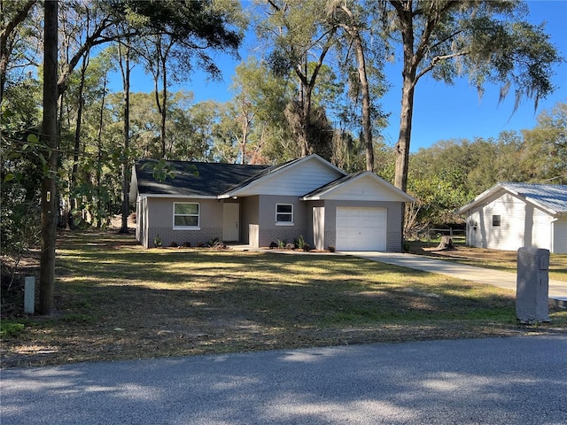 single story home featuring a garage and a front lawn