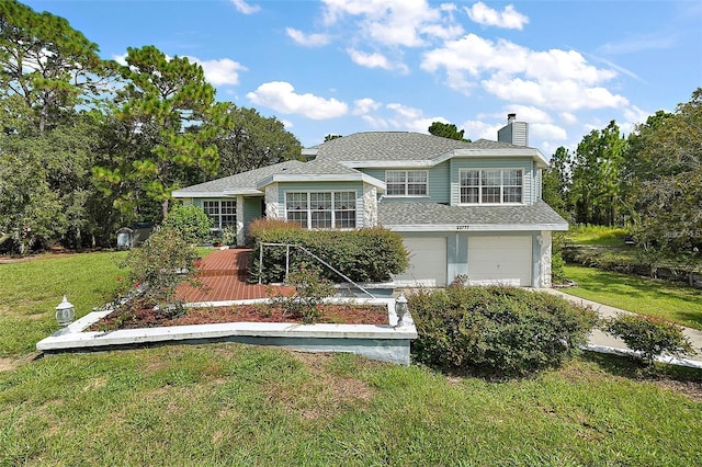 view of front facade with a front yard and a garage