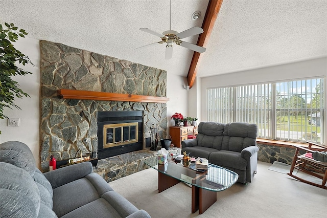 living room featuring a stone fireplace, ceiling fan, carpet floors, and vaulted ceiling with beams