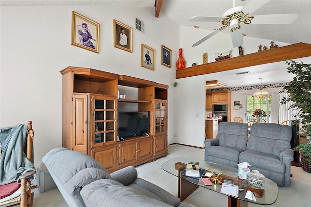 living room featuring lofted ceiling with beams, ceiling fan, and light colored carpet