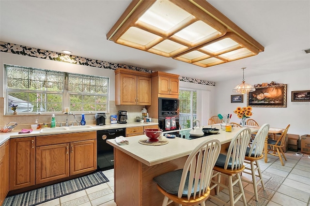 kitchen featuring sink, black appliances, light tile patterned floors, decorative light fixtures, and a center island