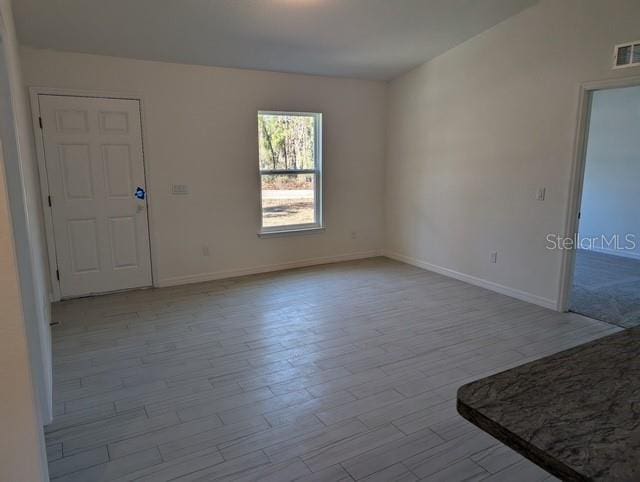 spare room with light hardwood / wood-style flooring