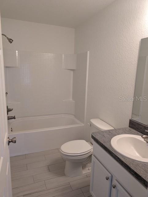 full bathroom featuring vanity, toilet, and bathtub / shower combination