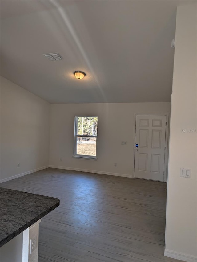 empty room with hardwood / wood-style flooring