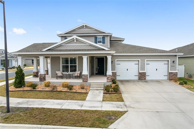 craftsman inspired home with a porch and a garage