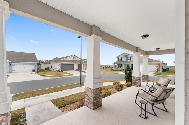 view of patio with a garage and covered porch