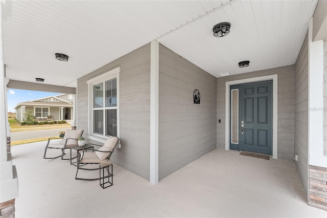 doorway to property featuring covered porch