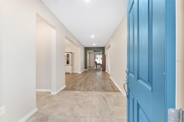 corridor with light tile patterned floors